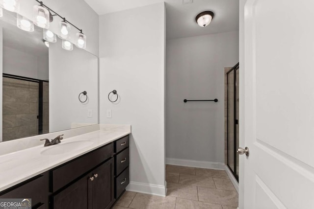 bathroom with tile patterned flooring, vanity, and a shower with shower door