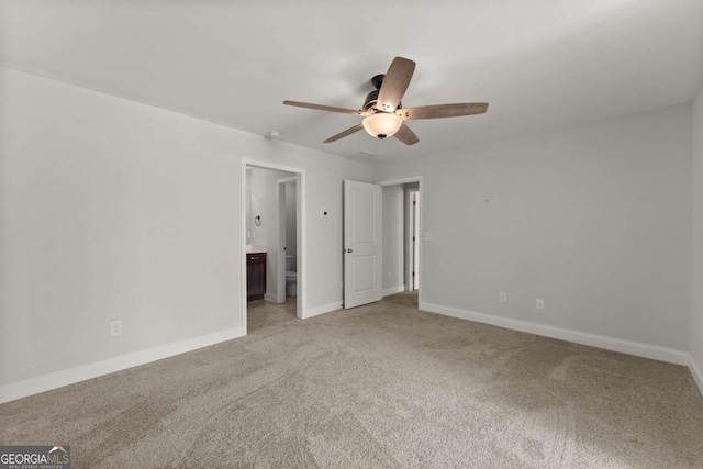 unfurnished bedroom with ceiling fan, light carpet, and connected bathroom