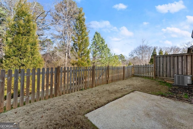 view of yard featuring a patio and central AC