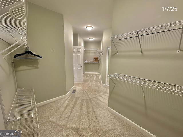 walk in closet featuring carpet