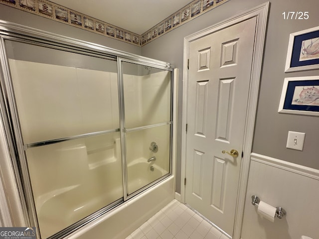 bathroom featuring tile patterned floors and shower / bath combination with glass door