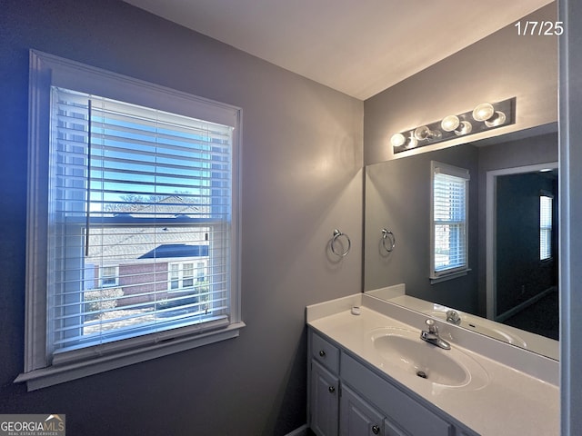 bathroom with plenty of natural light and vanity