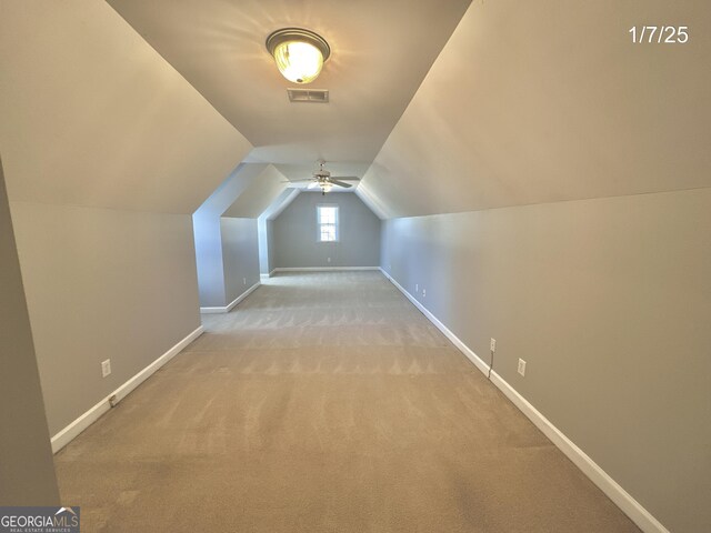 bonus room featuring light carpet, ceiling fan, and lofted ceiling