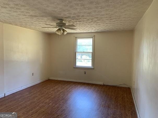 spare room with ceiling fan, a textured ceiling, and hardwood / wood-style flooring