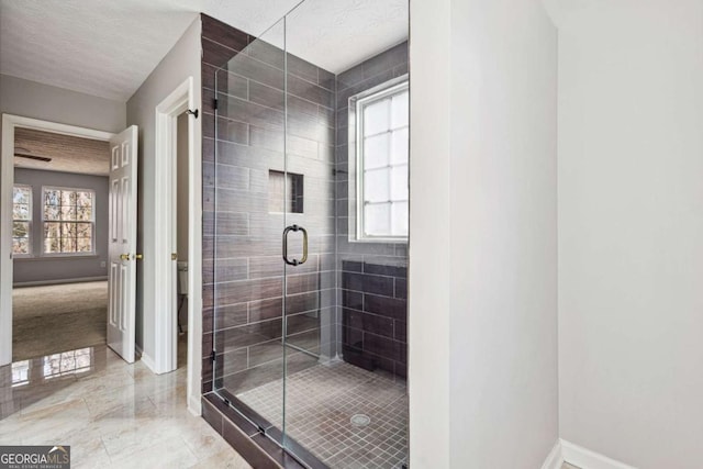 bathroom featuring walk in shower, a textured ceiling, and toilet