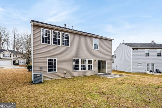 rear view of property with a yard, a patio, and central AC unit