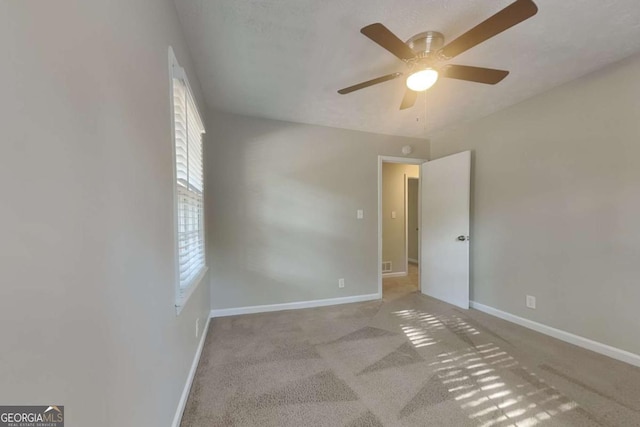 empty room with light carpet and ceiling fan