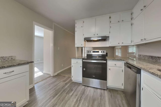 kitchen with stone counters, white cabinetry, appliances with stainless steel finishes, and light hardwood / wood-style flooring