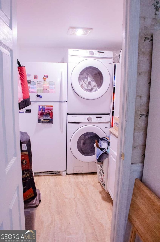 laundry room featuring stacked washer and dryer