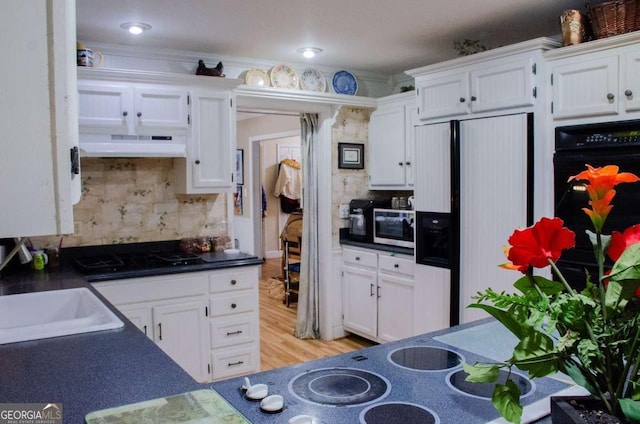 kitchen featuring tasteful backsplash, fridge with ice dispenser, white cabinetry, and black gas cooktop