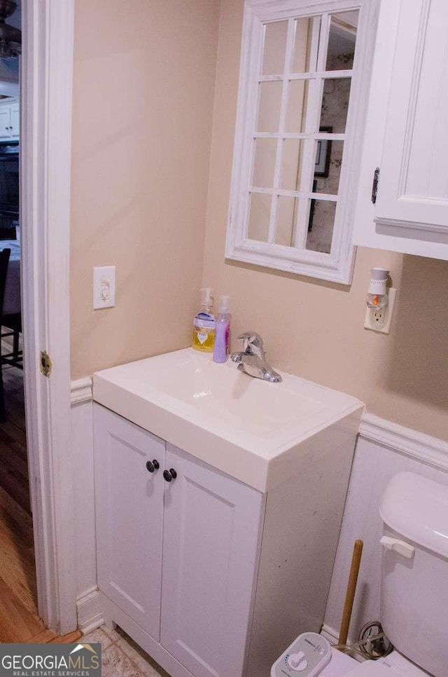 bathroom featuring vanity and toilet