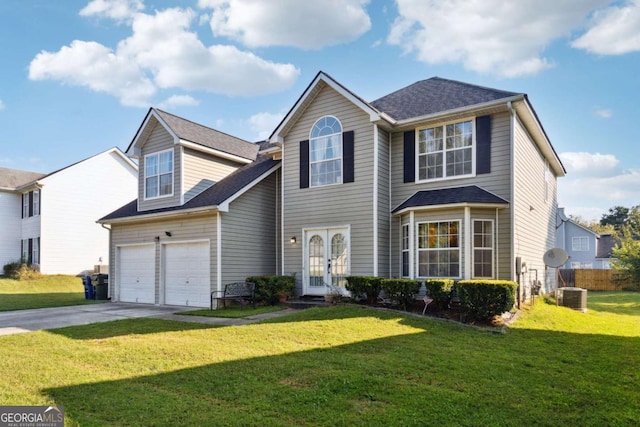 view of front facade with french doors, a garage, and a front lawn