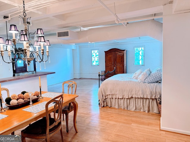 bedroom featuring a chandelier and light hardwood / wood-style flooring