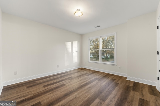 unfurnished room with dark hardwood / wood-style floors