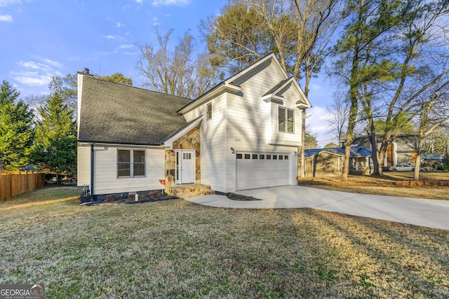 view of property featuring a front yard and a garage