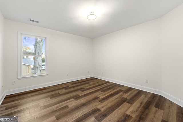 unfurnished room featuring dark hardwood / wood-style flooring