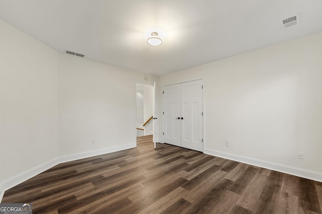 unfurnished room featuring dark wood-type flooring