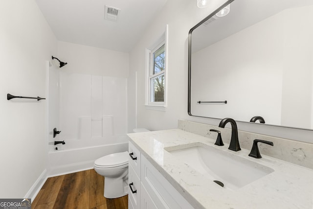 full bathroom featuring shower / washtub combination, hardwood / wood-style floors, vanity, and toilet