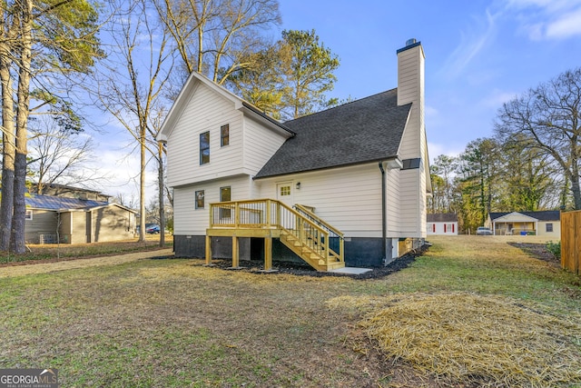 back of property featuring a lawn and a wooden deck