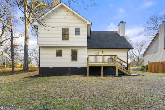 rear view of house featuring a wooden deck