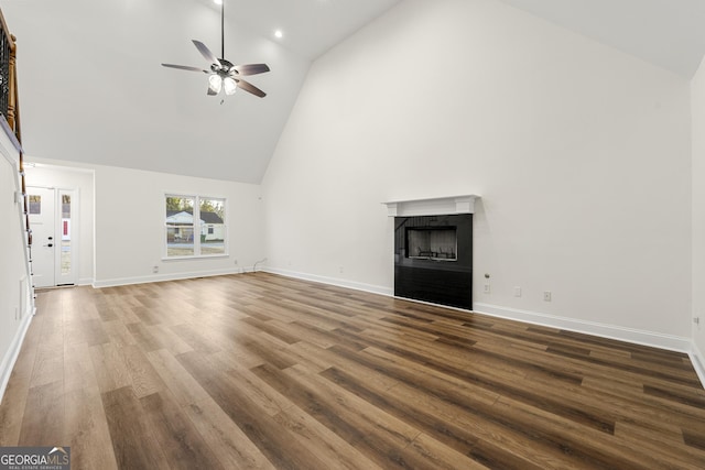 unfurnished living room featuring ceiling fan, wood-type flooring, and high vaulted ceiling