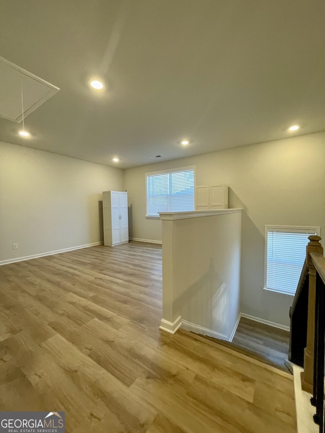 basement with light hardwood / wood-style floors