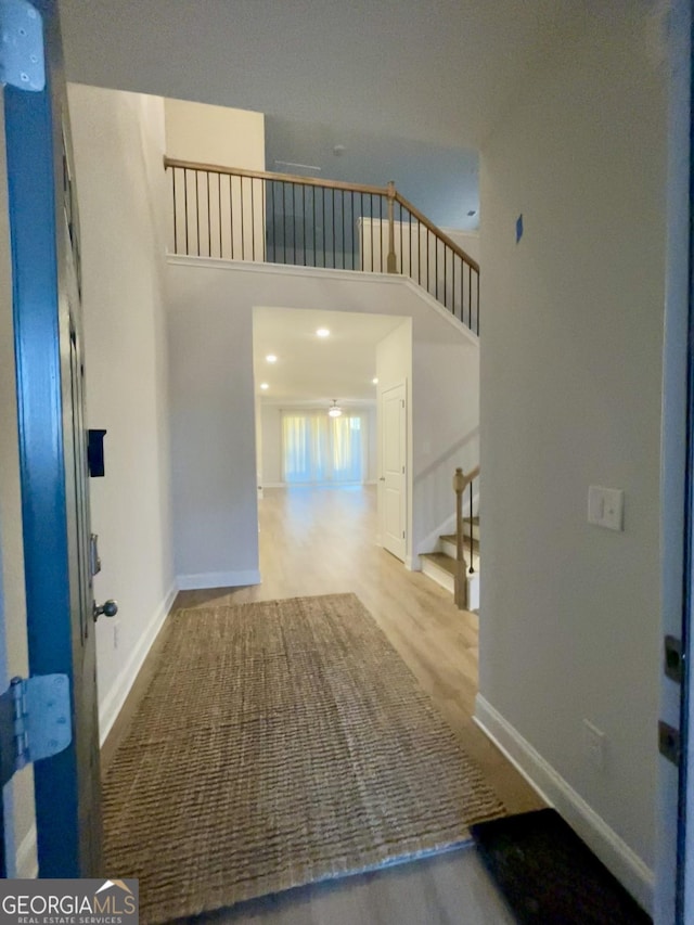 entryway with a high ceiling and light hardwood / wood-style floors