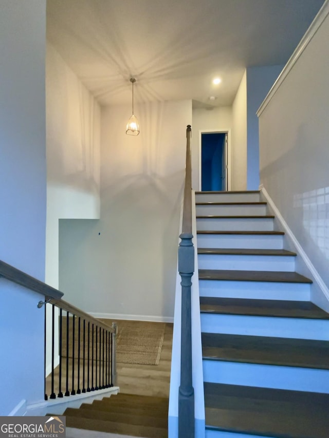 stairway featuring wood-type flooring