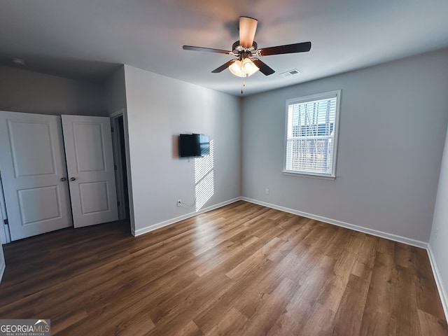 unfurnished bedroom featuring hardwood / wood-style flooring and ceiling fan