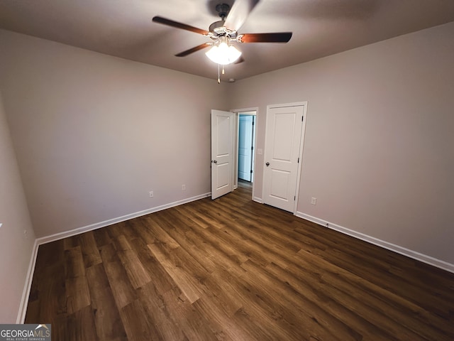 unfurnished bedroom featuring dark hardwood / wood-style floors and ceiling fan