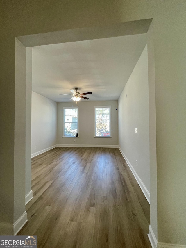 empty room with ceiling fan and light wood-type flooring