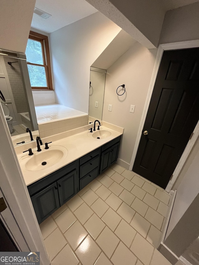 bathroom with vanity, a tub to relax in, and tile patterned floors