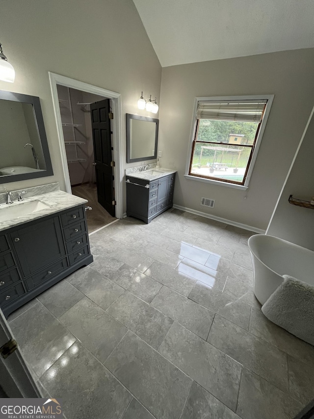 bathroom featuring vanity and vaulted ceiling