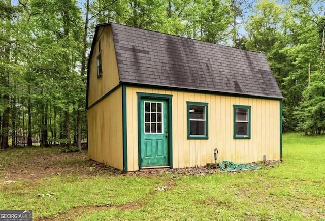 view of outbuilding featuring a lawn