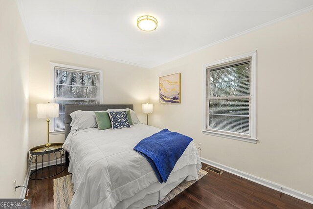 bedroom featuring hardwood / wood-style flooring and ornamental molding