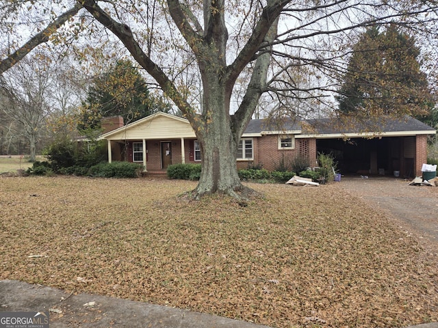 ranch-style home with a porch and a garage