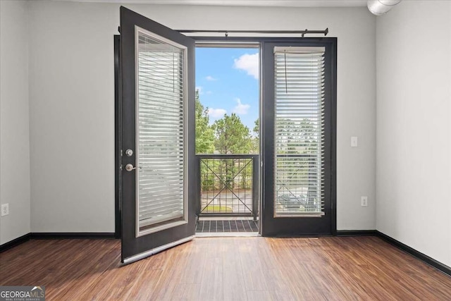 doorway with wood-type flooring