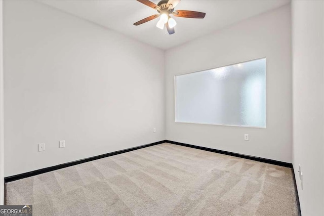 unfurnished room featuring light carpet and ceiling fan