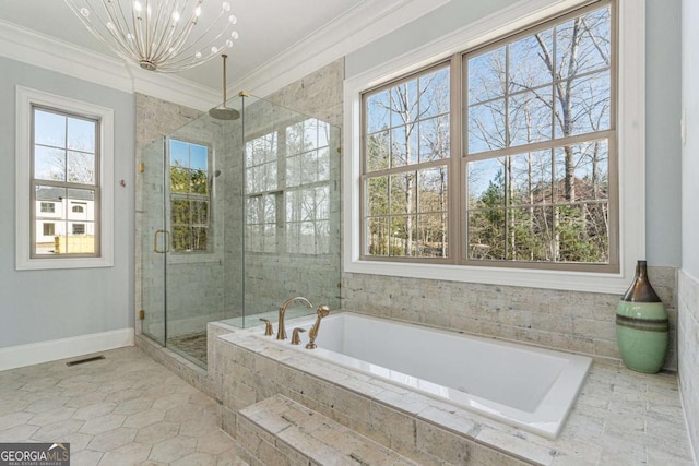 bathroom with tile patterned flooring, ornamental molding, independent shower and bath, and an inviting chandelier