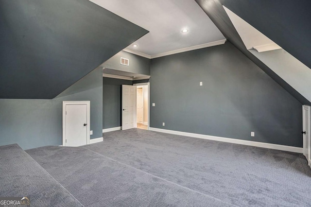 additional living space featuring carpet flooring and vaulted ceiling