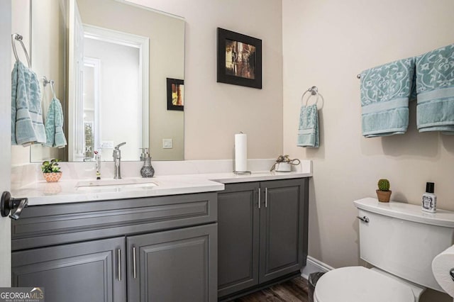 bathroom featuring hardwood / wood-style flooring, vanity, and toilet