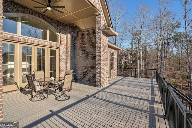 wooden deck with ceiling fan and french doors