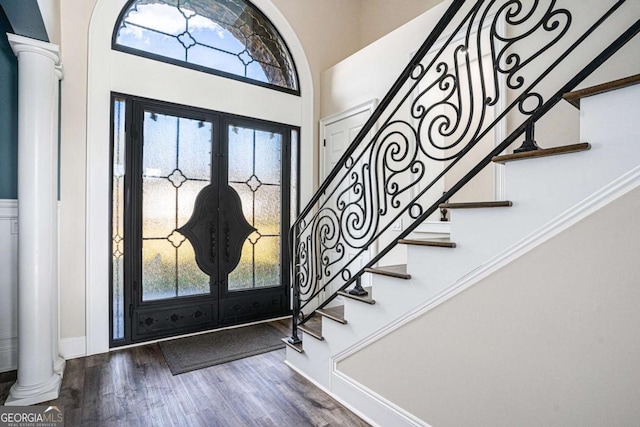 foyer entrance with french doors, ornate columns, and hardwood / wood-style floors