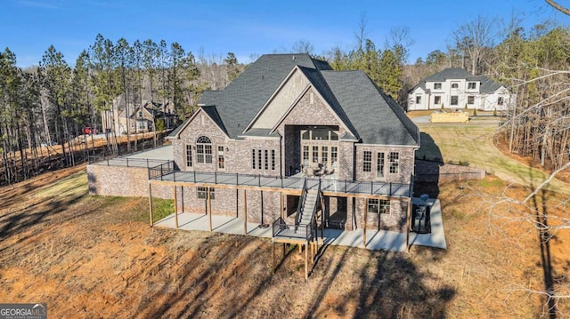 rear view of property with a patio area, a yard, and a deck