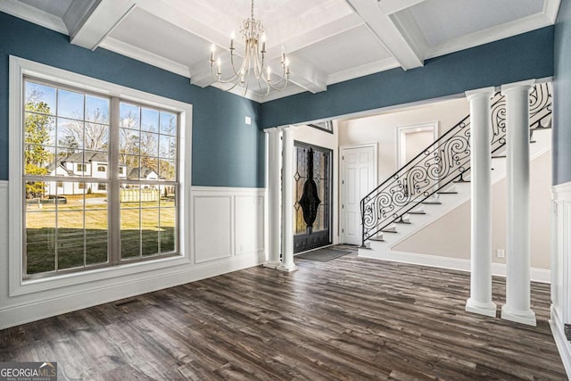 interior space with dark wood-type flooring, coffered ceiling, an inviting chandelier, ornamental molding, and beamed ceiling