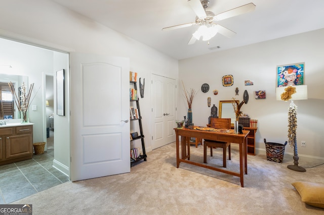 office space with ceiling fan and light colored carpet