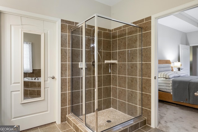 bathroom with tile patterned floors and a shower with door