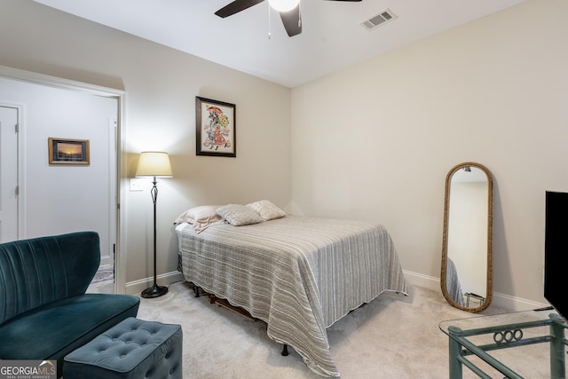 bedroom with ceiling fan and light carpet