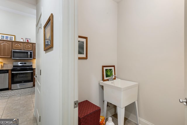 hall featuring light tile patterned floors