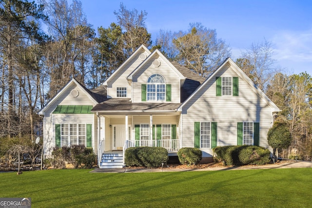 front facade featuring covered porch and a front lawn